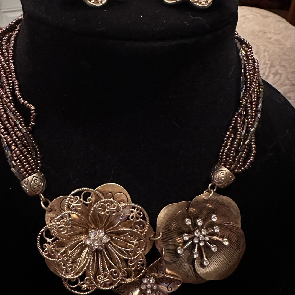 Brown multi strand necklace with gold flowers and matching earrings
